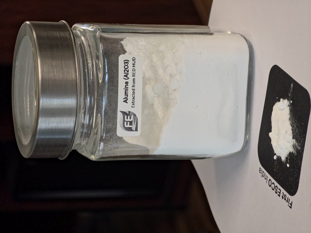 Alumina powder recovered from red mud, in a labelled specimen jar