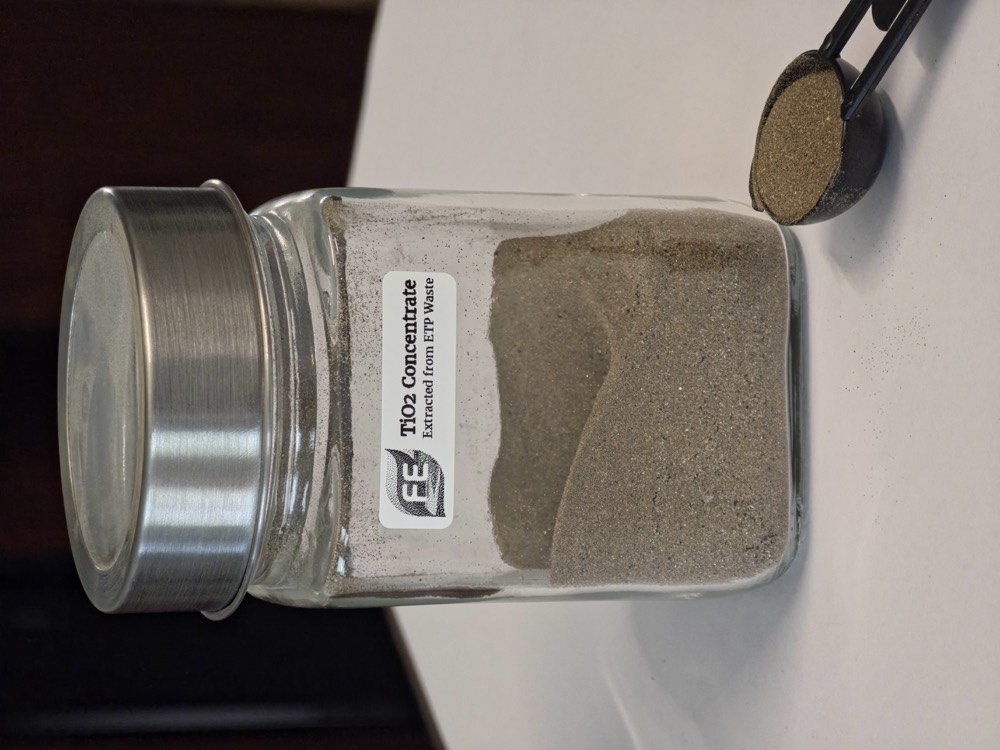 Titanium dioxide concentrate recovered from titanium ETP waste, in a labelled specimen jar